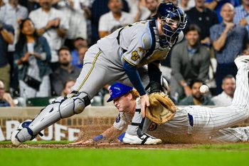 Aug 19, 2025; Chicago, Illinois, USA;  Chicago Cubs outfielder Owen Caissie (19) scores past Milwaukee Brewers catcher Danny  Jansen (33) during the second inning at Wrigley Field. Mandatory Credit: Matt Marton-Imagn Images