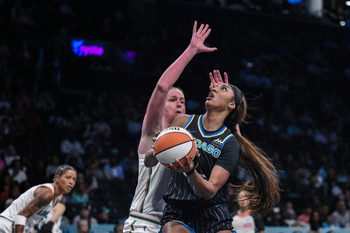 Aug 21, 2025; Brooklyn, New York, USA; Chicago Sky forward Angel Reese (5) shoots the ball while defended by New York Liberty center Emma Meesseman (33) during the first half at Barclays Center. Mandatory Credit: John Jones-Imagn Images