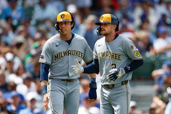 Aug 21, 2025; Chicago, Illinois, USA; Milwaukee Brewers second baseman Brice Turang (2) celebrates with designated hitter Christian Yelich (22) after hitting a two-run home run against the Chicago Cubs during the second inning at Wrigley Field. Mandatory Credit: Kamil Krzaczynski-Imagn Images