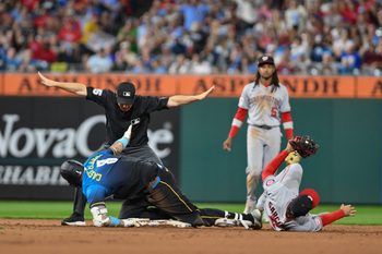 Aug 22, 2025; Philadelphia, Pennsylvania, USA; Philadelphia Phillies outfielder Nick Castellanos (8) slides safely into second base with a double against Washington Nationals second baseman Luis García Jr. (2) during the sixth inning at Citizens Bank Park. Mandatory Credit: John Jones-Imagn Images