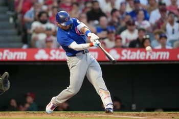 Aug 22, 2025; Anaheim, California, USA; Chicago Cubs designated hitter Seiya Suzuki (27) hits a RBI sacrifice fly in the third inning against the Los Angeles Angels at Angel Stadium. Mandatory Credit: Kirby Lee-Imagn Images