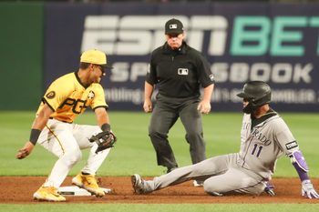 Aug 22, 2025; Pittsburgh, Pennsylvania, USA;  Colorado Rockies shortstop Orlando Arcia (11) slides safely into second base as Pittsburgh Pirates second baseman Nick Gonzales (39) attempts a tag during the sixth inning at PNC Park. Mandatory Credit: Charles LeClaire-Imagn Images