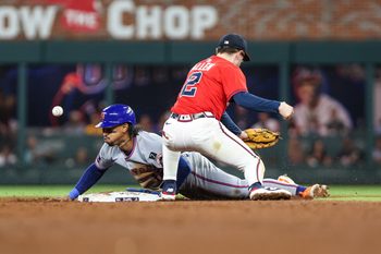 Aug 22, 2025; Cumberland, Georgia, USA; New York Mets shortstop Francisco Lindor (12) steals second base agaisnt Atlanta Braves shortstop Nick Allen (2) during the fifth inning at Truist Park. Mandatory Credit: Jordan Godfree-Imagn Images