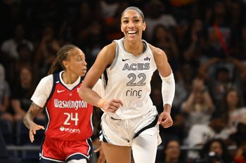 Aug 23, 2025; Washington, District of Columbia, USA;  Las Vegas Aces center A'ja Wilson (22) is all smiles after a basket against the Washington Mystics during the fourth quarter at CareFirst Arena. Mandatory Credit: Rafael Suanes-Imagn Images