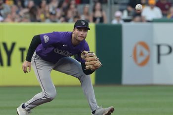 Aug 23, 2025; Pittsburgh, Pennsylvania, USA;  Colorado Rockies third baseman Kyle Karros (12) fields a ground ball for an out against Pittsburgh Pirates designated hitter Andrew McCutchen (not pictured) during the fourth inning at PNC Park. Mandatory Credit: Charles LeClaire-Imagn Images