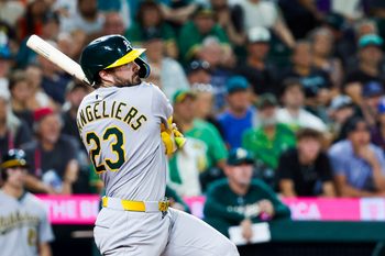 Aug 23, 2025; Seattle, Washington, USA; Athletics catcher Shea Langeliers (23) hits an RBI-double against the Seattle Mariners during the tenth inning at T-Mobile Park. Mandatory Credit: Joe Nicholson-Imagn Images