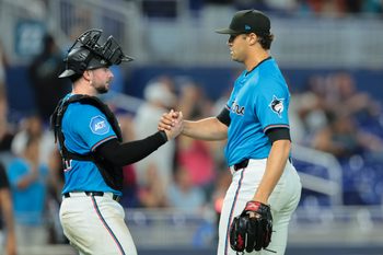 Aug 24, 2025; Miami, Florida, USA; Miami Marlins catcher Liam Hicks (34) and relief pitcher Tyler Phillips (30) celebrate after the game against the Toronto Blue Jays at loanDepot Park. Mandatory Credit: Sam Navarro-Imagn Images