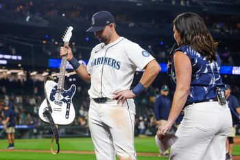 Aug 25, 2025; Seattle, Washington, USA; Seattle Mariners catcher Cal Raleigh (29) holds the “Vedder Cup” trophy for the winning the season series against the San Diego Padres following a victory Padres at T-Mobile Park. The “Vedder Cup” is named after Pearl Jam frontman Eddie Vedder. Mandatory Credit: Joe Nicholson-Imagn Images