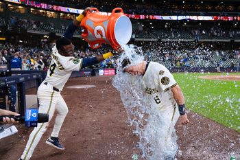 Aug 26, 2025; Milwaukee, Wisconsin, USA;  Milwaukee Brewers left fielder Isaac Collins (6) is dunked with Gatorade by  Andruw Monasterio (14) after driving in the winning run during the ninth inning against the Arizona Diamondbacks at American Family Field. Mandatory Credit: Jeff Hanisch-Imagn Images