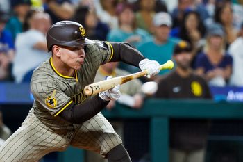 Aug 26, 2025; Seattle, Washington, USA; San Diego Padres catcher Freddy Fermin (54) hits an RBI-sacrifice bunt against the Seattle Mariners during the sixth inning at T-Mobile Park. Mandatory Credit: Joe Nicholson-Imagn Images