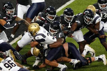 Navy Midshipmen fullback Anton Hall Jr. (34) carries the ball as Cincinnati Bearcats defensive lineman Jowon Briggs (18) makes the tackle near the goal line in the third quarter during a college football game, Saturday, Nov. 5, 2022, at Nippert Stadium in Cincinnati. The Cincinnati Bearcats won, 20-10.

Ncaaf Navy Midshipmen At Cincinnati Bearcats Nov 6 0672