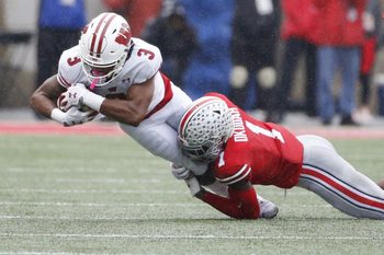 Ohio State Buckeyes cornerback Jeff Okudah (1) tackles Wisconsin Badgers wide receiver Kendric Pryor (3) during the first quarter of a NCAA Division I college football game between the Ohio State Buckeyes and the Wisconsin Badgers on Saturday, October 26, 2019 at Ohio Stadium in Columbus, Ohio. [Joshua A. Bickel/Dispatch]

Osu19wis Jb 30