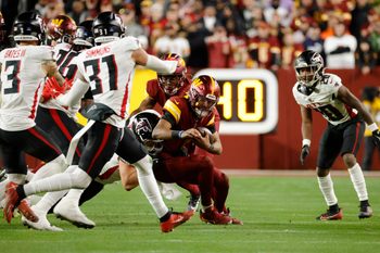 Dec 29, 2024; Landover, Maryland, USA; Washington Commanders quarterback Jayden Daniels (5) runs with the ball against the Atlanta Falcons during the second half at Northwest Stadium. Mandatory Credit: Amber Searls-Imagn Images