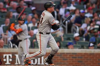 Jul 21, 2025; Atlanta, Georgia, USA; San Francisco Giants first baseman Wilmer Flores (41) hits a single against the Atlanta Braves in the fourth inning at Truist Park. Mandatory Credit: Brett Davis-Imagn Images