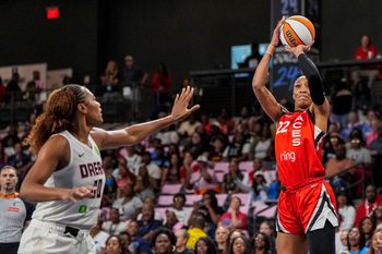 Aug 27, 2025; College Park, Georgia, USA; Las Vegas Aces center A'ja Wilson (22) shoots over Atlanta Dream forward Naz Hillmon (00) during the first half at Gateway Center Arena at College Park. Mandatory Credit: Dale Zanine-Imagn Images