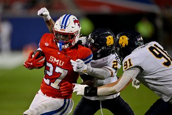 Aug 30, 2025; Dallas, Texas, USA; Southern Methodist Mustangs running back T.J. Harden (27) is tackled by East Texas A&M Lions defensive back Lavon Williams (2) and defensive lineman Micah Johnson (91) during the second half at Gerald J. Ford Stadium. Mandatory Credit: Jerome Miron-Imagn Images