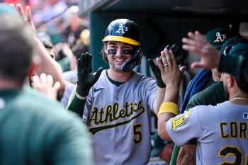 Sep 1, 2025; St. Louis, Missouri, USA;  Athletics shortstop Jacob Wilson (5) is congratulated by teammates after scoring against the St. Louis Cardinals during the seventh inning at Busch Stadium. Mandatory Credit: Jeff Curry-Imagn Images