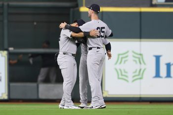 Sep 2, 2025; Houston, Texas, USA; New York Yankees left fielder Jasson Dominguez (24) and center fielder Trent Grisham (12) and right fielder Cody Bellinger (35) celebrate after the game against the Houston Astros at Daikin Park. Mandatory Credit: Troy Taormina-Imagn Images