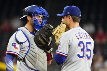 Texas Rangers catcher Kyle Higashioka (11) talks to pitcher Jack Leiter (35) against the Arizona Diamondbacks in the second inning at Chase Field on Sept. 3, 2025.