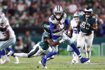 Sep 4, 2025; Philadelphia, Pennsylvania, USA; Philadelphia Eagles cornerback Jakorian Bennett (23) tackles Dallas Cowboys wide receiver CeeDee Lamb (88) during the second quarter of the game at Lincoln Financial Field. Mandatory Credit: Bill Streicher-Imagn Images