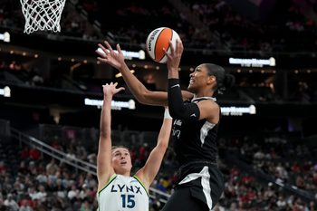 Sep 4, 2025; Las Vegas, Nevada, USA; Las Vegas Aces center A'ja Wilson (22) shoots against Minnesota Lynx forward Jessica Shepard (15) in the second quarter of their game at T-Mobile Arena. Mandatory Credit: Candice Ward-Imagn Images