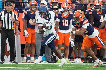 Sep 6, 2025; Syracuse, New York, USA; UConn Huskies wide receiver Reymello Murphy (6) runs after a catch against the Syracuse Orange during the second half at JMA Wireless Dome. Mandatory Credit: Gregory Fisher-Imagn Images