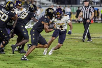 Sep 6, 2025; Orlando, Florida, USA; UCF Knights running back Jaden Nixon (5) carries the ball against North Carolina A&T Aggies cornerback Aaron Harris (4) during the second half at Acrisure Bounce House. Mandatory Credit: Mike Watters-Imagn Images
