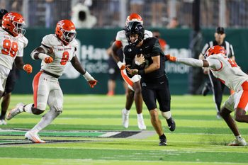 Sep 6, 2025; Honolulu, Hawaii, USA;  Hawaii Rainbow Warriors quarterback Luke Weaver (2) weaves through the Sam Houston Bearkats defense during the third quarter at Clarence T.C. Ching Athletics Complex. Mandatory Credit: Marco Garcia-Imagn Images