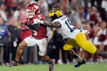 Oklahoma's Isaiah Sategna III (5) get by Michigan's Ernest Hausmann (15) in the second half of the college football game between the University of Oklahoma Sooner and the University of Michigan Wolverines at the Gaylord Family Ð Oklahoma Memorial Stadium in Norman, Okla., Saturday, Sept. 6, 2025.