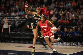 Sep 7, 2025; Baltimore, MD, USA; Indiana Fever guard Kelsey Mitchell (0) drives to the basket in front of Washington Mystics forward Shakira Austin (0) during the first quarter at CFG Bank Arena. Mandatory Credit: Rafael Suanes-Imagn Images