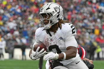 Sep 7, 2025; Foxborough, Massachusetts, USA; Las Vegas Raiders running back Ashton Jeanty (2) rushes the ball against the New England Patriots during the second half at Gillette Stadium. Mandatory Credit: Bob DeChiara-Imagn Images