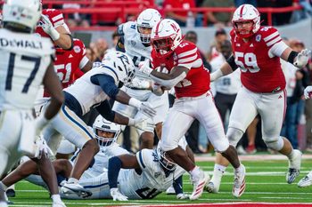 Sep 6, 2025; Lincoln, Nebraska, USA; Nebraska Cornhuskers running back Emmett Johnson (21) runs against Akron Zips defenders during the second quarter at Memorial Stadium. Mandatory Credit: Dylan Widger-Imagn Images