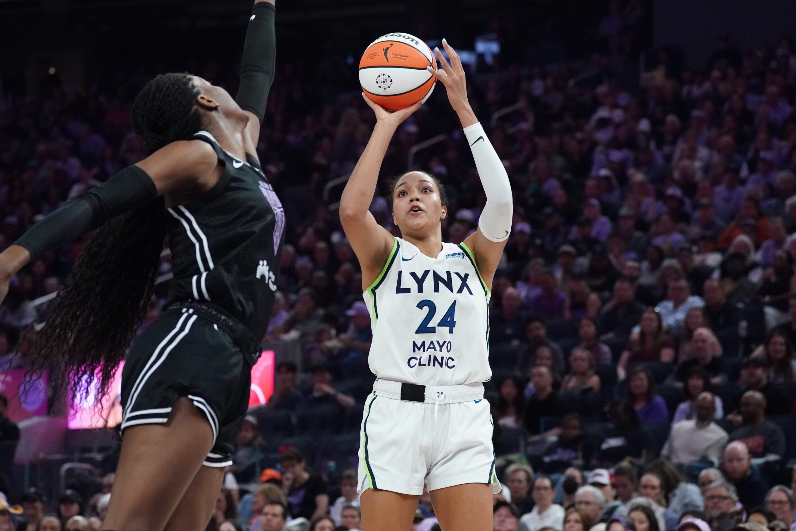 Sep 6, 2025; San Francisco, California, USA; Minnesota Lynx forward Napheesa Collier (24) shoots over Golden State Valkyries center Temi Fagbenle (14) in the second quarter at Chase Center. Mandatory Credit: David Gonzales-Imagn Images