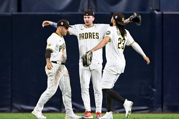 Sep 11, 2025; San Diego, California, USA; San Diego Padres right fielder Ramon Laureano (5), left, Jackson Merrill (3), center, and  Fernando Tatis Jr. (23) celebrate after the Padres defeated the Colorado Rockies at Petco Park. Mandatory Credit: Denis Poroy-Imagn Images