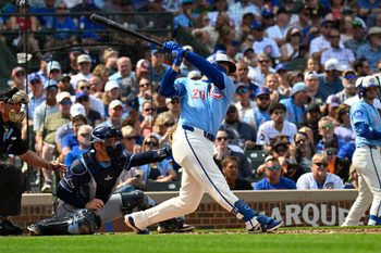 Sep 12, 2025; Chicago, Illinois, USA;  Chicago Cubs first baseman Michael Busch (29) hits an RBI single against the Tampa Bay Rays during the second inning at Wrigley Field. Mandatory Credit: Matt Marton-Imagn Images