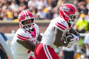 Sep 13, 2025; Columbia, Missouri, USA; Louisiana-Lafayette Ragin Cajuns quarterback Lunch Winfield (2) hands off to running back Zylan Perry (3) against the Missouri Tigers during the first half of the game at Faurot Field at Memorial Stadium. Mandatory Credit: Denny Medley-Imagn Images