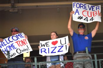 Sep 13, 2025; Chicago, Illinois, USA; Fans hold up signs for former Chicago Cubs player Anthony Rizzo during a game against the Tampa Bay Rays at Wrigley Field. Mandatory Credit: Patrick Gorski-Imagn Images
