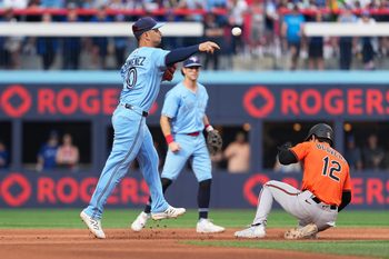 Sep 13, 2025; Toronto, Ontario, CAN; Baltimore Orioles right fielder Dylan Beavers (12) is tagged out at second base by Toronto Blue Jays shortstop Andres Gimenez (0) during the eighth inning at Rogers Centre. Mandatory Credit: Nick Turchiaro-Imagn Images