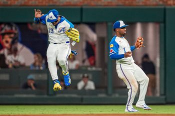 Sep 13, 2025; Cumberland, Georgia, USA; Atlanta Braves right fielder Ronald Acuna Jr (13) and second baseman Ozzie Albies (1) avoid a collision after Albies catches a pop up against the Houston Astros during the ninth inning at Truist Park. Mandatory Credit: Dale Zanine-Imagn Images