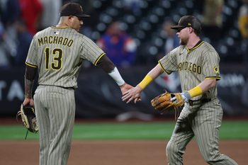 Sep 17, 2025; New York City, New York, USA; San Diego Padres second baseman Jake Cronenworth (9) celebrates with third baseman Manny Machado (13) after the game against the New York Mets at Citi Field. Mandatory Credit: Vincent Carchietta-Imagn Images