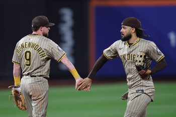 Sep 17, 2025; New York City, New York, USA; San Diego Padres second baseman Jake Cronenworth (9) celebrates with right fielder Fernando Tatis Jr. (23) after the game against the New York Mets at Citi Field. Mandatory Credit: Vincent Carchietta-Imagn Images