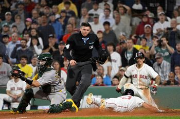 Sep 17, 2025; Boston, Massachusetts, USA; Boston Red Sox third baseman Nate Eaton (40) slides across home plate against Athletics catcher Shea Langeliers (23) to score the winning run off an RBI by first baseman Nick Sogard (20) (not pictured) during the tenth inning at Fenway Park. Mandatory Credit: Eric Canha-Imagn Images