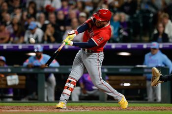 Sep 19, 2025; Denver, Colorado, USA; Los Angeles Angels third baseman Yoan Moncada (5) hits a sacrifice fly RBI in the fifth inning against the Colorado Rockies at Coors Field. Mandatory Credit: Isaiah J. Downing-Imagn Images