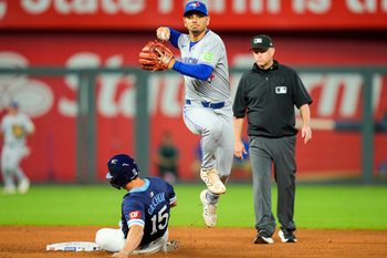 Sep 19, 2025; Kansas City, Missouri, USA; Toronto Blue Jays shortstop Andres Gimenez (0) forces out Kansas City Royals right fielder Randal Grichuk (15) during the seventh inning at Kauffman Stadium. Mandatory Credit: Jay Biggerstaff-Imagn Images