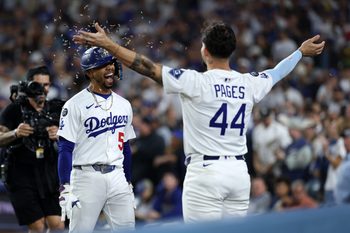 Sep 19, 2025; Los Angeles, California, USA;  Los Angeles Dodgers shortstop Mookie Betts (left) celebrates with center fielder Andy Pages (44) after hitting a solo home run during the fifth inning against the San Francisco Giants at Dodger Stadium. Mandatory Credit: Kiyoshi Mio-Imagn Images