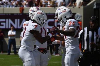 Sep 20, 2025; Blacksburg, Virginia, USA;  Virginia Tech Hokies wide receiver Cameron Seldon (9) celebrates with running back Braydon Bennett (24) after a touchdown run during the first quarter against the Wofford Terriers  at Lane Stadium. Mandatory Credit: Brian Bishop-Imagn Images