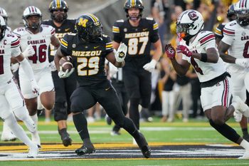 Sep 20, 2025; Columbia, Missouri, USA; Missouri Tigers running back Ahmad Hardy (29) runs the ball as South Carolina Gamecocks defensive back Vicari Swain (4) defends during the first half of the game at Faurot Field at Memorial Stadium. Mandatory Credit: Denny Medley-Imagn Images