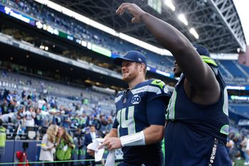Sep 21, 2025; Seattle, Washington, USA; Seattle Seahawks quarterback Sam Darnold (14) walks off the field after the game against the New Orleans Saints at Lumen Field. Mandatory Credit: Joe Nicholson-Imagn Images