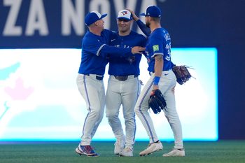 Sep 25, 2025; Toronto, Ontario, CAN; Toronto Blue Jays left fielder Anthony Santander (left) and center fielder Daulton Varsho (center) and right fielder Nathan Lukes (right) celebrate a win over the Boston Red Sox during the ninth inning at Rogers Centre. Mandatory Credit: John E. Sokolowski-Imagn Images