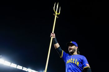 Sep 25, 2025; Seattle, Washington, USA; Seattle Mariners third baseman Eugenio Suarez (28) raises the trident to celebrate a victory against the Colorado Rockies at T-Mobile Park. Mandatory Credit: Joe Nicholson-Imagn Images
